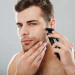 attractive masculine male being undressed at home having skincar